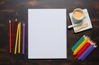 empty white paper mockup and colorful crayons on the brown table with coffee with milk  flat lay. Artistic workplace template. Arts and crafts.