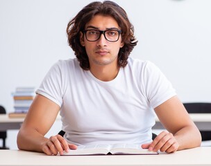 Wall Mural - Young male student sitting in the classroom