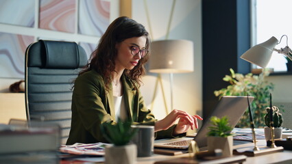Wall Mural - Focused business woman typing at laptop in office closeup. Girl surfing internet