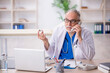 © Elnur - Old male doctor in telemedicine concept