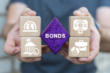 Wall Mural - Man holding blocks sees word: BONDS. Bonds investment Business Finance concept. Corporate Bond Banking Market Management.