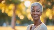 © Barbara Taylor - a beautiful older black woman with short stylish hair, dress in nice simple clothes, walking in a park, copy space