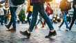 Dynamic urban pulse: Unseen faces stride purposefully in a bustling cityscape, emphasizing the rhythm of life through a focus on anonymous feet and legs
