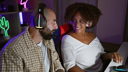 Poster - Two gamers smiling confident sitting on table speaking at gaming room