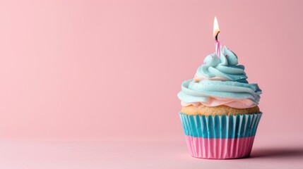 Light pink and light blue cupcake with one candle