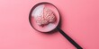 Magnifying glass and human brain on pink background, mental health care concept