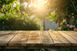 © Cheetose - A wooden table with no objects on it and a blurred outdoor garden background. The wooden table provides space for text and can be used for marketing promotions