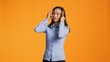 © DC Studio - Asian young adult suffers from painful migraine in studio, rubbing temples to ease temples pressure. Sick worried woman feeling under stress, dealing with headache and tension.