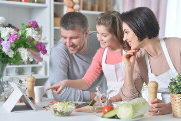 Portrait of young family cooking together at home