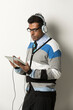 © Image Smith - Indian man with tablet PC listen to music.