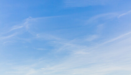 white clouds spread thinly in the blue sky