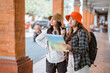© Odua Images - two Asian tourists look at a map on their way to a tourist destination