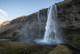 Fototapeta Tęcza - view of the shaded waterfall complex Seljalandsdoss, Iceland