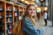 Smiling cute pretty blond girl, positive female teenage high school student holding backpack looking at camera standing in modern university or college campus library, Generative AI