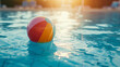 Summer holidays background with colorful beach ball floating on luxury swimming pool and copy space