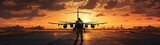 Fototapeta  - The silhouette of a military airplane on the runway, bathed in the warm hues of a sunset at the airport.