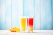 glasses of red and yellow juice with color gradient