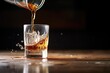 pouring bourbon into glass, ice cubes splashing