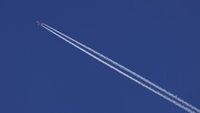 The Journey Begins, Plane Flies High In The Sky, Leaving A White Trail. Jet Airplane Flying Overhead In Clear Blue Sky And Leaving Nice Contrail. Plane Smoothly As It Flies Through The Sky