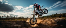 Motorcycle Stunt Or Car Jump, A Off Road Moto Cross Type Motor Bike In Mid Air During A Jump With A Dirt Trail