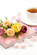 Flowers on books, a cup of tea and marmalade sweet hearts for a romantic mood. Poster for interior. Still life on a white background.