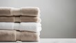 Light white spa towels pile, bath towels lying in a stack on light white peaceful background 

