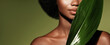 Organic skin care. Beauty portrait of young beautiful african american woman posing with exotic green leaf