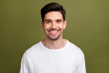 Poster - Portrait of cheerful satisfied young man toothy beaming smile good mood isolated on khaki color background