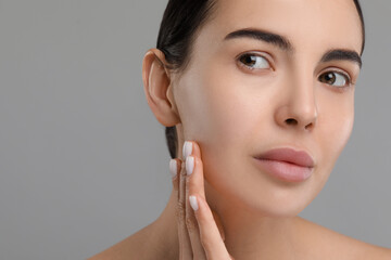 Poster - Young woman with dry skin on gray background, closeup. Space for text