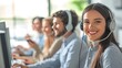 © Евгений Федоров - A diverse team of professionals in a call-center, smiling as they assist customers with their computer expertise. Copy space.
