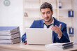 © Elnur - Young male employee and too much work in the office
