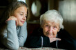 Portrait of a teenage girl with her great-grandmother.