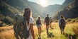 © bannafarsai - A young female and male student hiking in the mountains