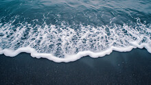 Black Sand Beach And Waves.
