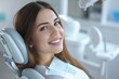 © Attasit - A happy woman is sitting in a dentist's chair and looking directly at the camera. Capture the positive atmosphere and her contentment during the dental visit
