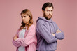 Portrait of offended couple standing and feeling sad with crossed arms 