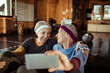 © Davor - Two smiling senior women taking selfie in indoor gym