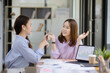 © SOMKID - Technology and financial advisory services concept. Business teamwork and working on digital laptop computer with advisor showing plan of investment to clients at table office. Digital marketing.