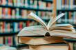 © epiximages - open book lying on a stack of books in a library
