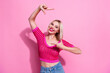 Photo of positive cute person toothy smile arms fingers demonstrate cadre gesture isolated on pink color background