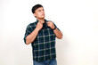 © ArvStd - Confident young adult asian man standing while touching his shirt with arrogant face expression