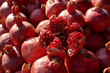 Lots of ripe pomegranates at the market stall.  Pomegranate fruit grains. Selective focus.