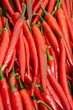 Food texture or background of red hot chili peppers.  Street vegetable market. A group of red chili peppers.