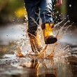 © aljna - A child runs through puddles in rubber boots. Dirty splashes. view from below, close-up.