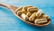 Vegetarian multivitamin capsules on a blue background. Food supplement, multivitamins, medicines, dietary fiber close up3 - Copy.jpg