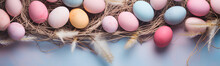 Colorful Easter Eggs In A Straw Basket. Pastel Colored Background.