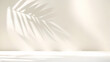 Blurred shadow from palm leaves on light cream wall. Minimalistic beautiful summer spring background for product presentation.