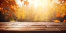Ideal For Showcasing Products, An Unfocused Autumn Morning Behind An Empty Wooden Table.