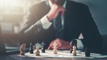 Business, Management, Planning, Strategy, Chart, Plan, Leader, Manager, Chess, Professional. Businessman Moving Chess Piece On Chess Board Game And Consider To Move Set In Next Turn For Win.