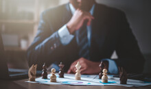 Business, Management, Planning, Strategy, Chart, Plan, Leader, Manager, Chess, Professional. Businessman Moving Chess Piece On Chess Board Game And Consider To Move Set In Next Turn For Win.